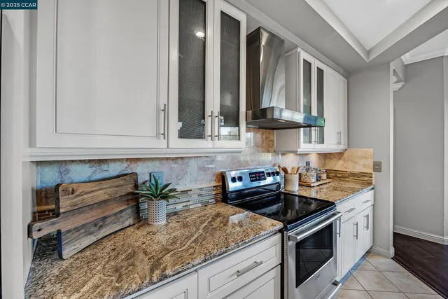a kitchen with stainless steel appliances granite countertop a sink stove and cabinets