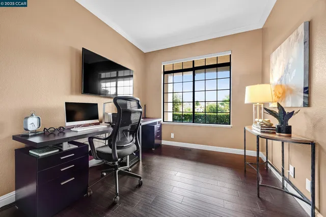 a view of a workspace with furniture and a window