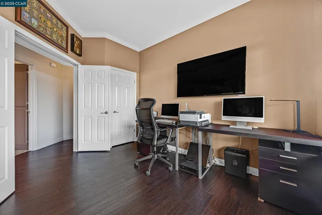 a view of a workspace with furniture and wooden floor