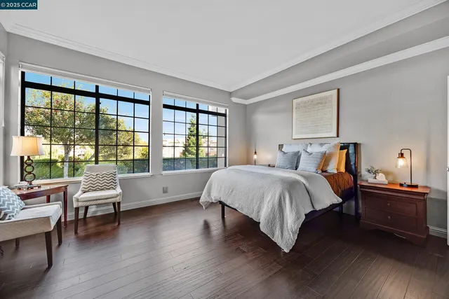 a spacious bedroom with a bed and a large window