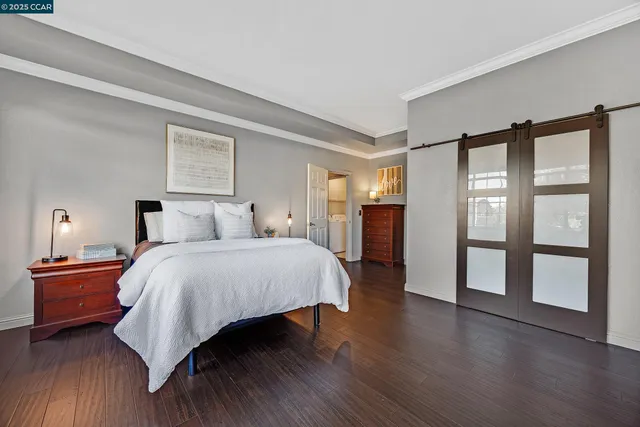 a bedroom with a large bed and a large window