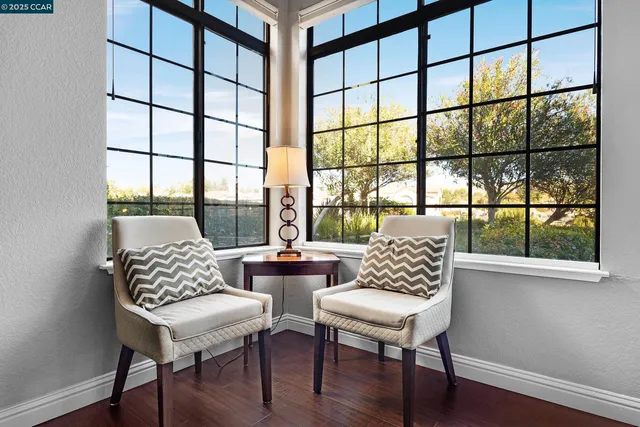 a view of a workspace with furniture and window