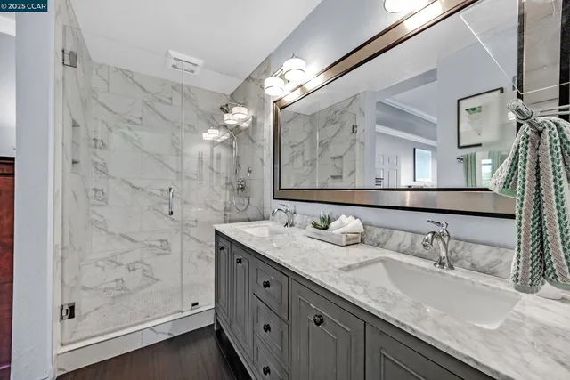 a bathroom with a granite countertop sink mirror and double