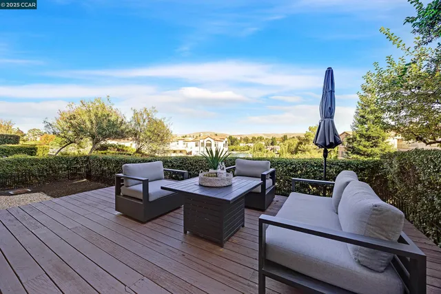 a view of a terrace with couches and wooden floor