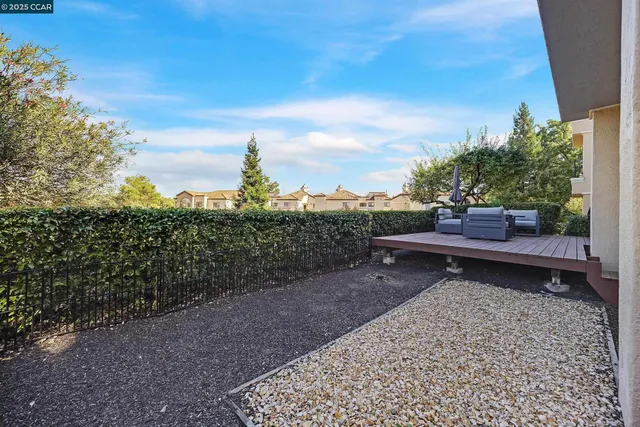 a wooden bench sitting in the middle of a yard