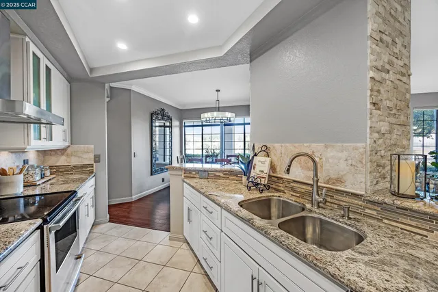 a kitchen with a sink and a stove top oven