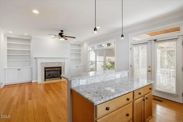 a kitchen with granite countertop a stove a sink and a wooden floors