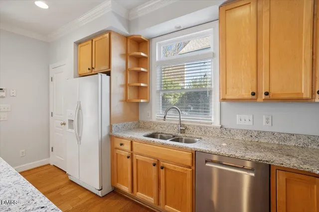 a kitchen with stainless steel appliances granite countertop a sink and a granite counter tops with a large window