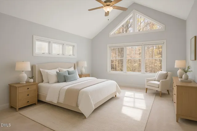 an empty room with chandelier fan and windows