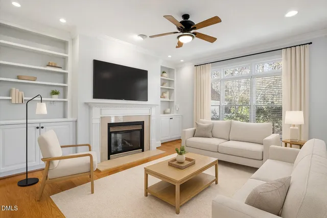a living room with furniture a fireplace and a flat screen tv