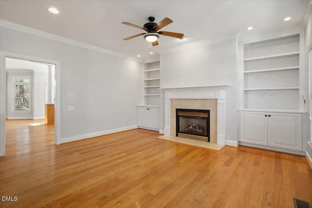 a view of an empty room with a fireplace and a window