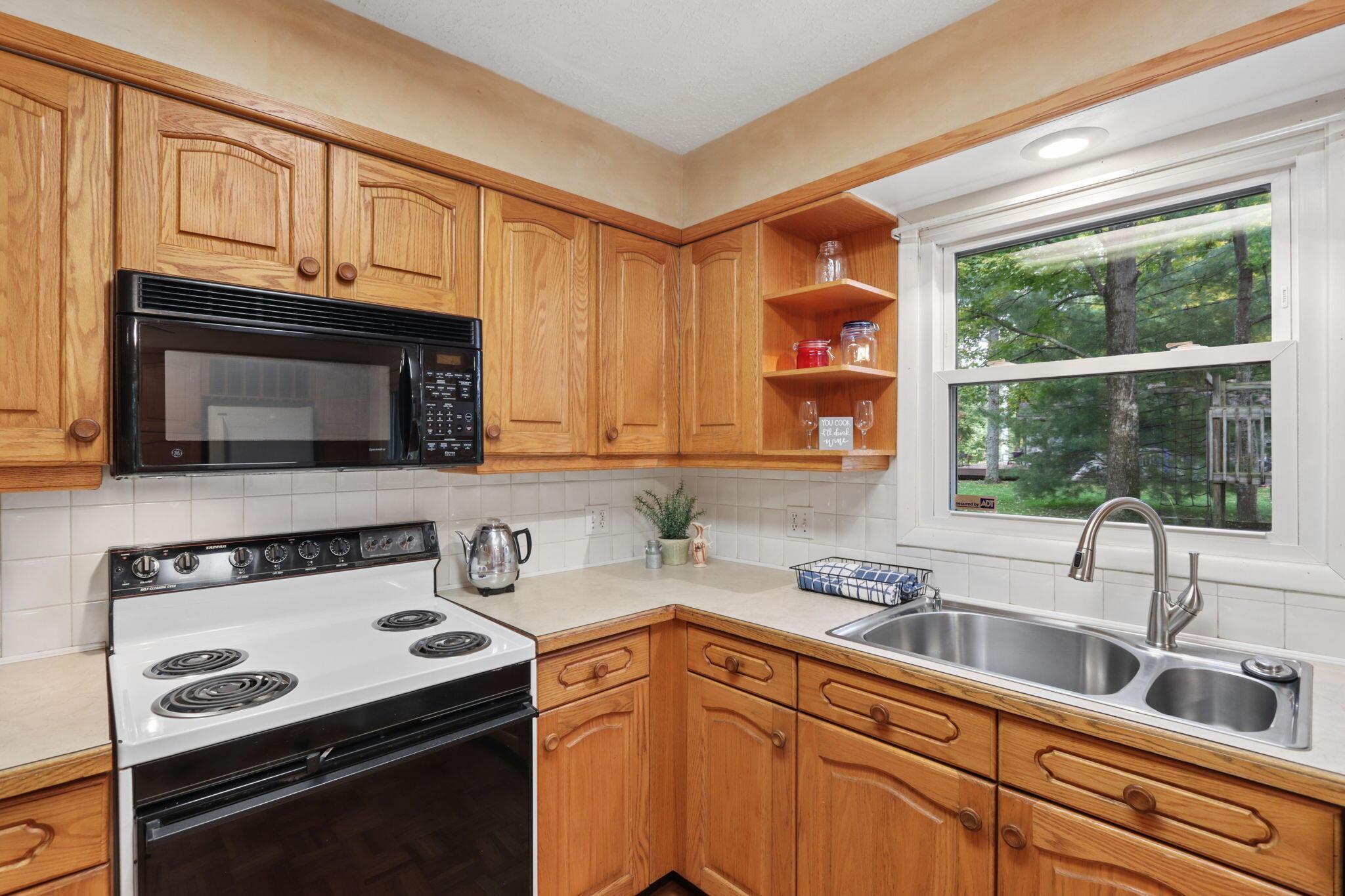 7115 Watkins Road Southwest Pataskala, OH 43062 - Photo 10 of 43 Stainless steel double basin sink with modern faucet, built-in microwave