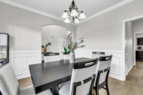 a view of a dining room with furniture and wooden floor