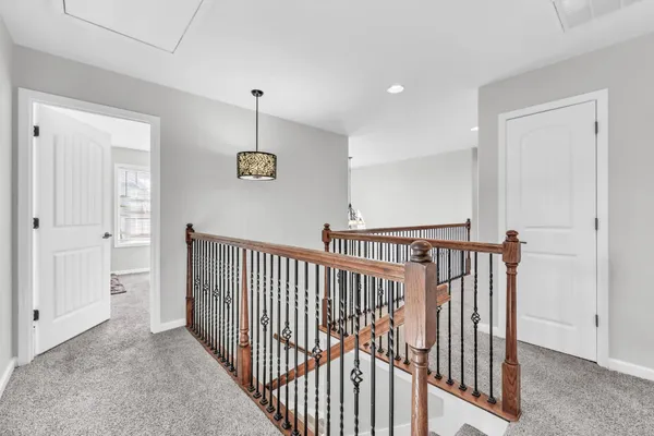 a view of a hallway with a door and stairs