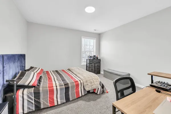 a bedroom with a bed and window