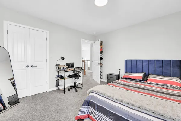 a bed room with a bed and a chair