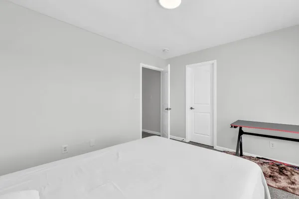 a bedroom with a bed and a closet