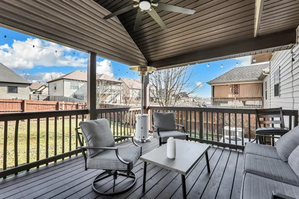 a view of a balcony with chairs and wooden floor