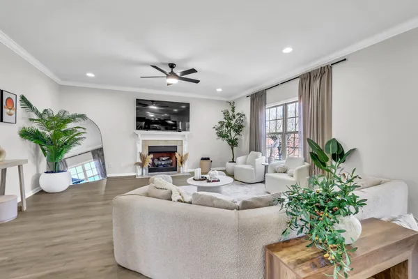 a living room with furniture fireplace and a large window