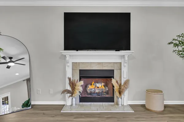a living room with a fireplace and a flat screen tv