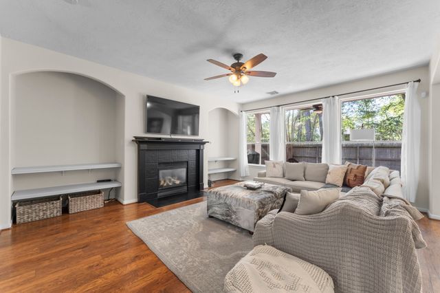 a living room with furniture fireplace and a large window