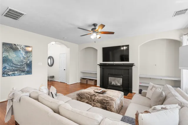 a living room with furniture fireplace and flat screen tv