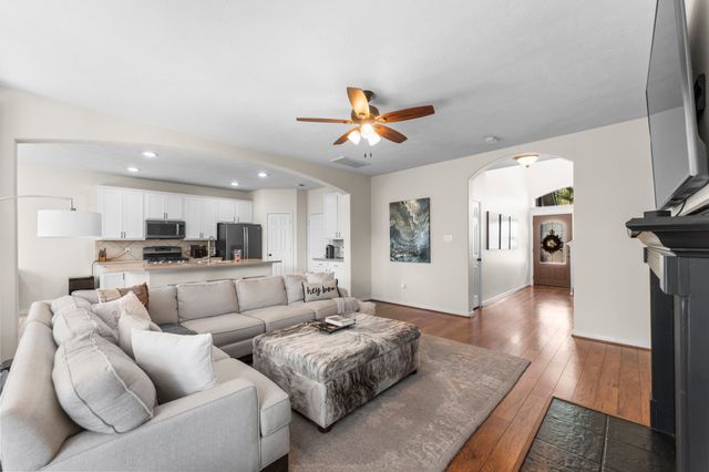 a living room with furniture a fireplace and a flat screen tv