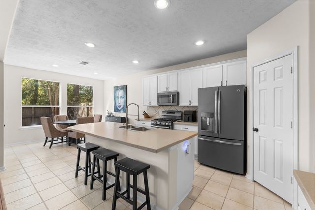 a living room with furniture and a view of kitchen