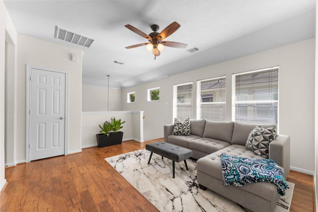 a living room with furniture and wooden floor