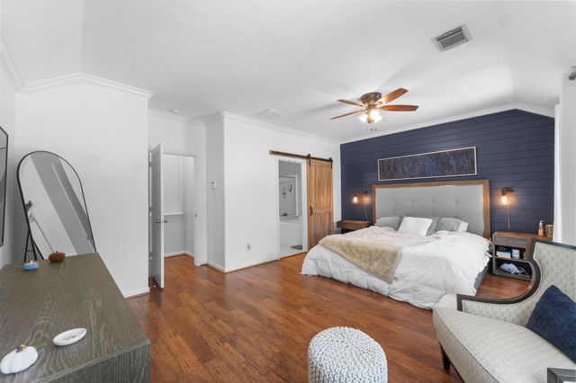 a bedroom with a bed and a television