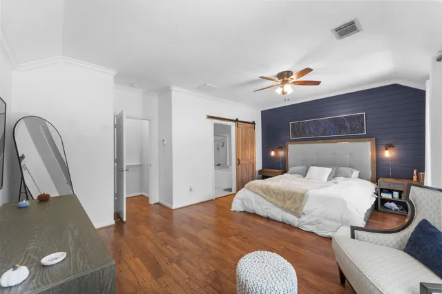 a bedroom with a bed and a television