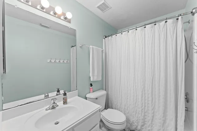 a bedroom with a bed window and wooden floor