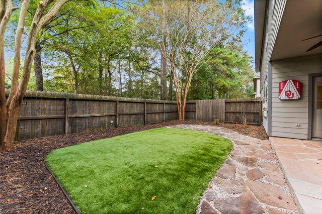 a view of a backyard with wooden fence