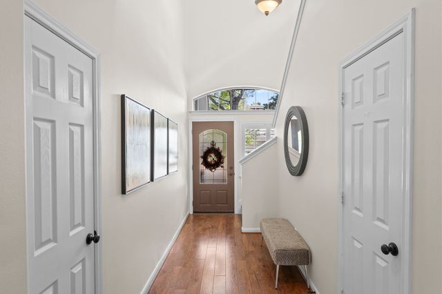 a view of entryway with furniture and wooden floor