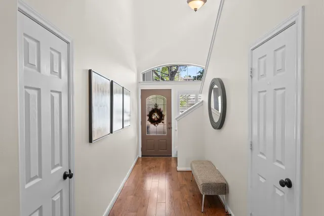 a view of entryway with furniture and wooden floor