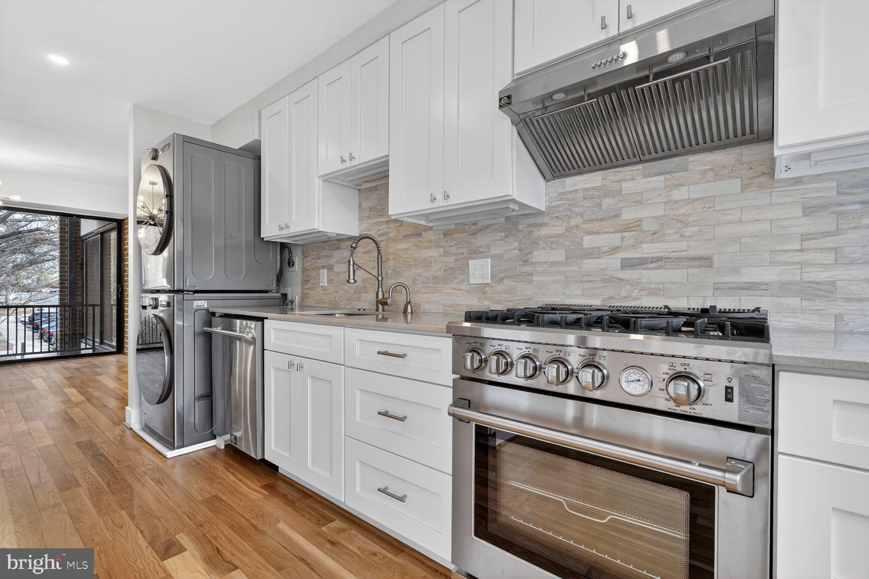9802 Georgia Avenue, Unit 26202 Silver Spring, MD 20902 - Photo 11 of 31 a kitchen with granite countertop a stove a sink and a refrigerator
