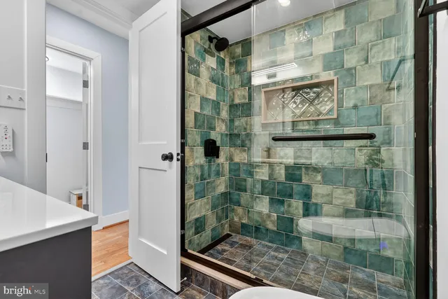 a bathroom with a glass shower door