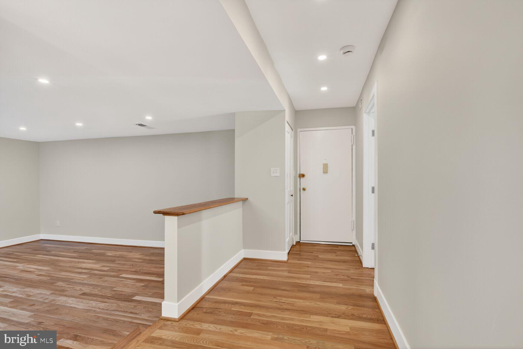 9802 Georgia Avenue, Unit 26202 Silver Spring, MD 20902 - Photo 3 of 31 a view of a hallway with wooden floor