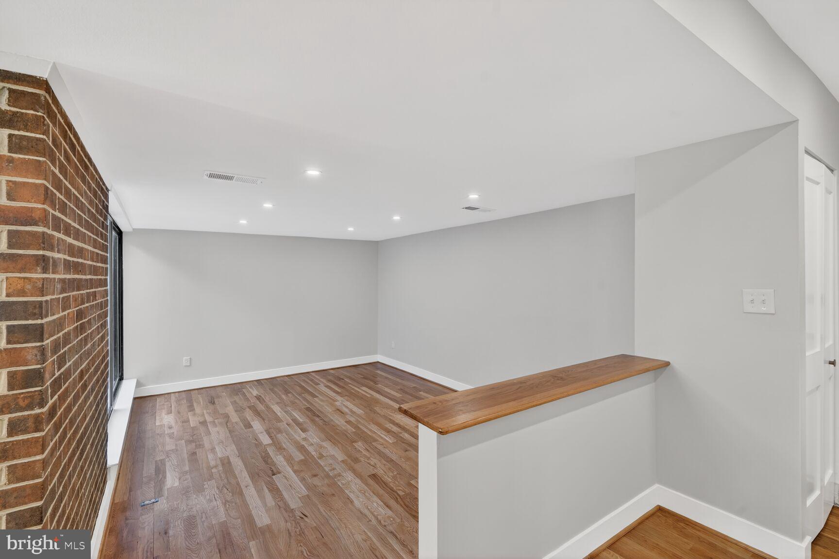 9802 Georgia Avenue, Unit 26202 Silver Spring, MD 20902 - Photo 6 of 31 a view of room with wooden floor