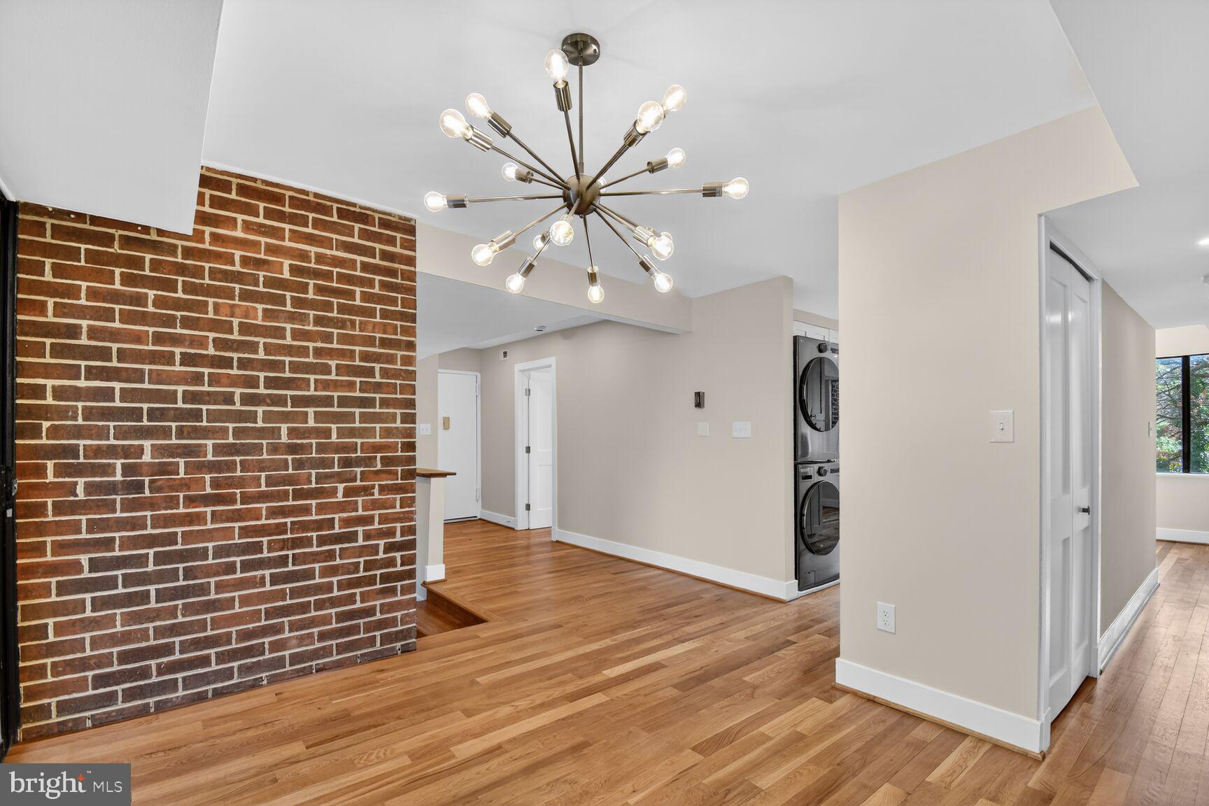 9802 Georgia Avenue, Unit 26202 Silver Spring, MD 20902 - Photo 7 of 31 a view of a livingroom with a chandelier fan and wooden floor