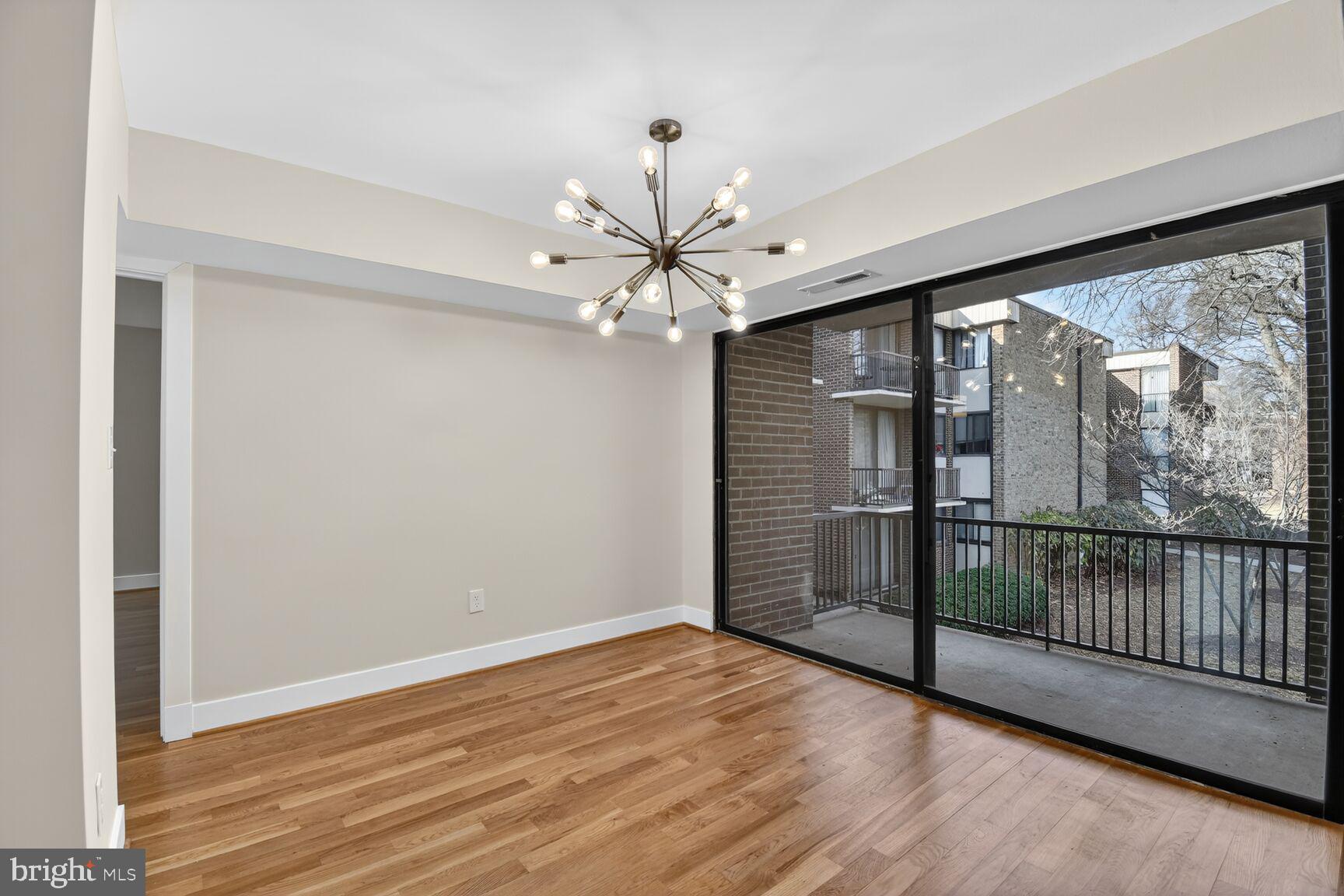 9802 Georgia Avenue, Unit 26202 Silver Spring, MD 20902 - Photo 8 of 31 a view of an empty room with wooden floor and a window