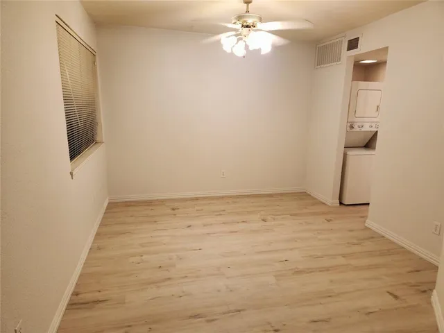 a view of an empty room with a fan