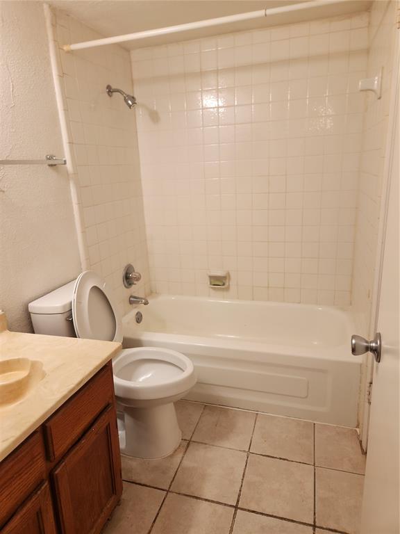 9813 Walnut Street, Unit 104 Dallas, TX 75243 - Photo 15 of 19 a bathroom with a sink a toilet and shower