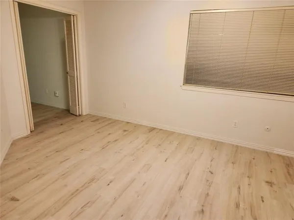 an empty room with wooden floor