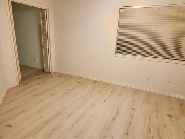 an empty room with wooden floor