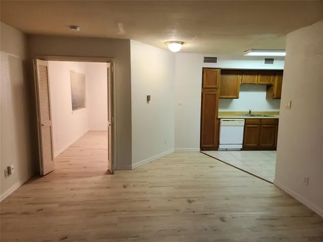 a view of a kitchen with a sink and a stove top oven