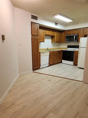 a kitchen with stainless steel appliances a refrigerator and a sink