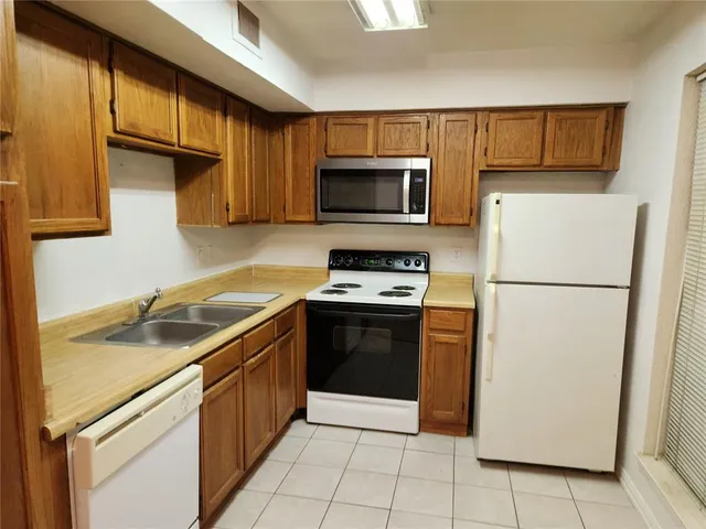 a kitchen with a refrigerator sink and microwave