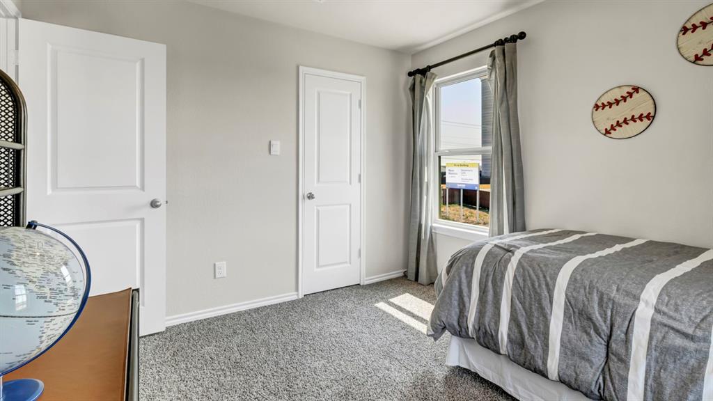 124 Pheasant Run Road Terrell, TX 75160 - Photo 9 of 35 Carpeted room featuring multiple panel doors, a large window with drapes, and neutral wall paint