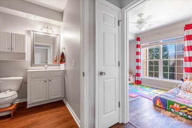 a bathroom with a sink mirror vanity and toilet